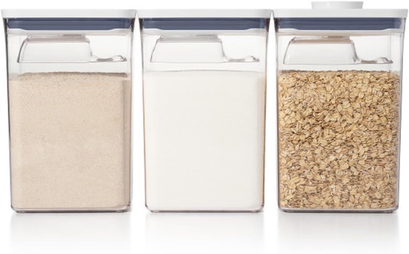 Clear storage canisters filled with pantry staples (flour, sugar, oats)