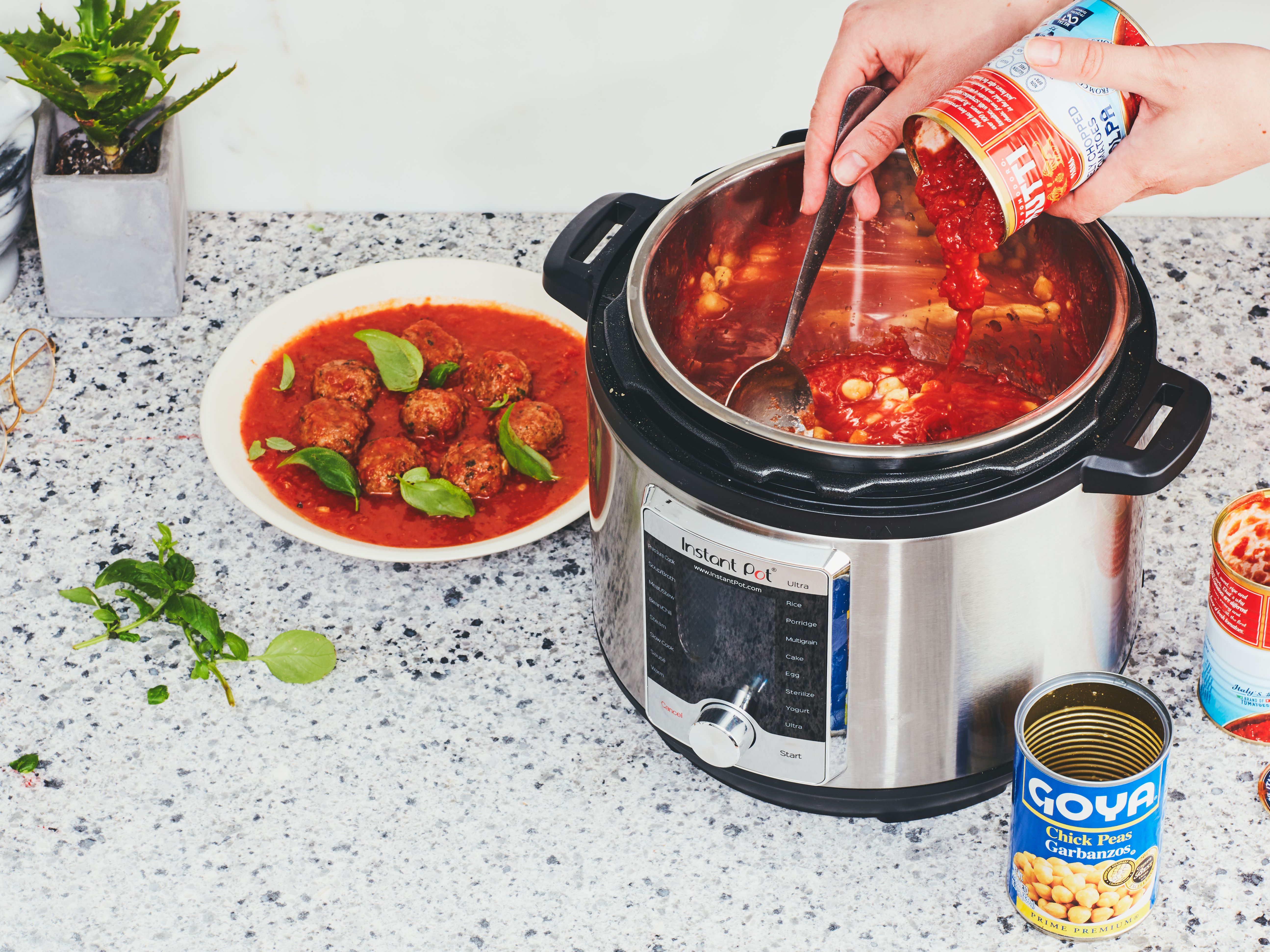 Small pressure cooker (Instant Pot) being used to cook meatballs